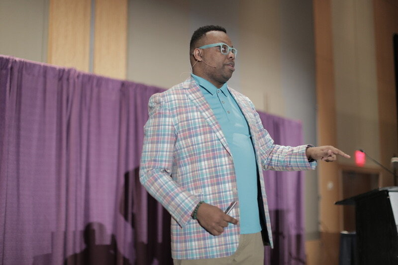 Adam speaking to a conference audience